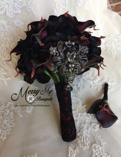 a bridal bouquet with black roses and brooches