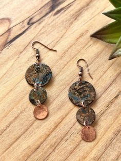 Handmade Earrings - Raw Copper Patina Ships anywhere in the US from Bellingham, Washington Item Details:   Unique Copper patina circle dangle earrings with raw copper details. These earrings are hand hammered and Patinaed by me. The colors and texture on these are gorgeous.  This pair is a beautiful, darkened copper with bronze, burnt orange, blue and dark accents.  Very light weight and versatile. Patina is a passion of mine because we love the results. This process of this verdigris patina takes five days.  Patina is a unique finish, and no two pair will be exactly alike but will strongly resemble the picture.  The copper patina pieces are covered by a thin layer of lacquer in order to save natural color of patina.  NOTE: Earrings are shipped with raw copper ear wires as shown in photogr Patina Earrings, Bellingham Washington, Bohemian Style Jewelry, Bronze Patina, Copper Patina, Brass Necklace, Copper Necklace, Circle Necklace, Cool Necklaces