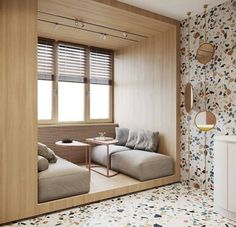 a living room filled with furniture next to a wall covered in flowered wallspaper