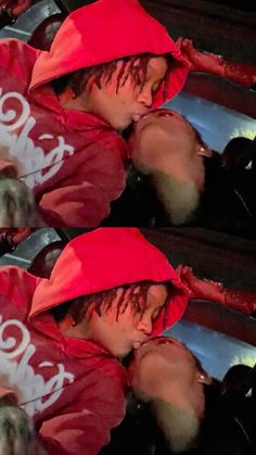 two people wearing red hats are kissing each other