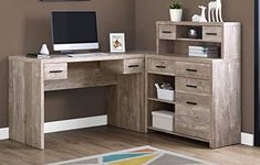 a desk with a computer on top of it in front of a brown wall and wooden floor