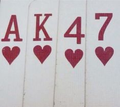 four playing cards with hearts and the letters ak 477 written in red on them