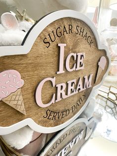 there is a sign that says sugar shack ice cream served daily on the shelf in front of it