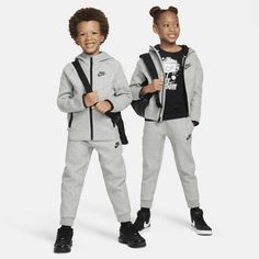 Made of bonded jersey knit fabric, this 2-piece set is inspired by the classic warmup suit. The hoodie has a full-zip closure that makes layering easy, and the matching tapered pants have ribbed cuffs and an elasticized waistband for a comfy fit little athletes can play freely in. Nike Hooded Activewear For Jogging, Nike Tracksuit For Sports, Gray Tracksuit With Ribbed Cuffs For Sports, Nike Hooded Winter Tracksuit, Nike Hooded Tracksuit Athleisure, Nike Hooded Tracksuit In Athleisure Style, Nike Hooded Sporty Tracksuit, Nike Sporty Hooded Tracksuit, Nike Hooded Tracksuit For Fall