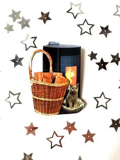 a cat sitting in a basket next to a heater with stars on the wall behind it