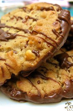 three chocolate chip cookies on a white plate