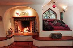 a living room filled with furniture and a fire place in the middle of a room