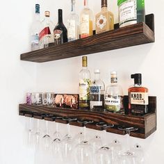 there are many bottles and glasses on the shelf