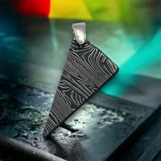 We are bringing you a touch of heaven for your self or that person in your life! This Pendant was made out of Meteorite Damascus steel. It contains 40 % Gibeon Iron meteorite and High Carbon tool steel. Gibeon  Iron meteorite came from one of the largest iron meteorite finds in Namibia, Africa. This very beautiful and unusual meteorite was first found in 1836, although native inhabitants knew about it before then. Most specimens show flight markings and evidence of a violent atmospheric breakup. A beautiful fine octahedrite pattern when etched and is very resistant to rust because of the tight fitting crystals, lack of inclusions, and high nickel content. It also displays a beautiful Widmanstaten Pattern. Makes a great and unique gift from out of this world.  Meteorites are older and rarer Meteor Jewelry, Touch Of Heaven, Namibia Africa, Meteorite Jewelry, 6th Anniversary Gifts, Space Rocks, Iron Meteorite, 6th Anniversary, Silver Chain Style