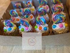 cupcakes decorated with candy and candies in a box