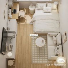 an overhead view of a small bedroom and living room with wood flooring, white bedding and furniture