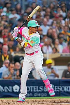 a baseball player holding a bat on top of a field in front of a crowd