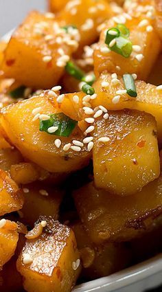 a white plate topped with pineapple and sesame seeds