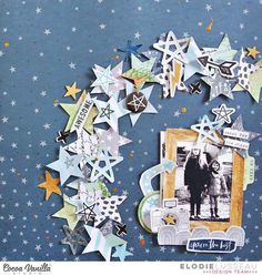 a scrapbook page with paper stars and an image of a couple in the middle