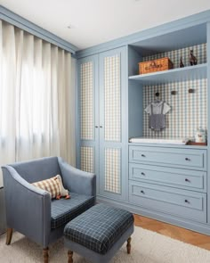 a baby's room with blue furniture and checkered wallpaper