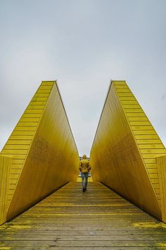 the person is walking up and down the yellow stairs that lead to the top of the building