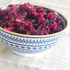 a bowl filled with red cabbage on top of a table