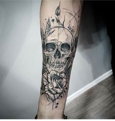 a black and white skull with roses on it's leg