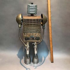 an old fashioned robot holding a baseball bat