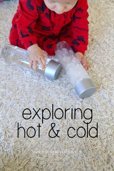 a toddler playing with an empty can on the floor that says exploring hot and cold