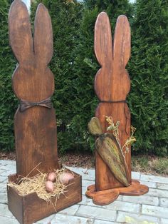 two wooden sculptures made to look like rabbits