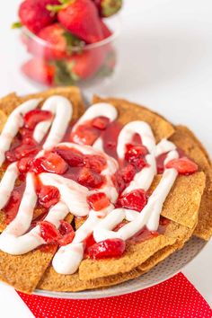 strawberries and cream are on top of tortilla chips with strawberrys in the background