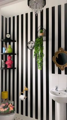 a bathroom with black and white striped walls