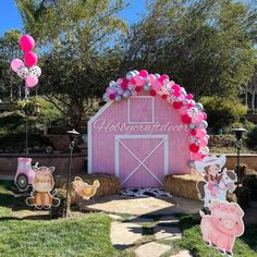 a pink barn decorated with balloons and farm animals