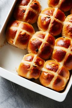 hot cross buns in a white baking dish