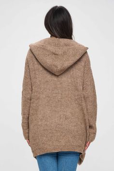 This brown hoodie is not your typical hoodie. It has a unique shrug style that sets it apart from other hoodies you may have seen before with pockets. The shrug design creates a layered effect, with the upper part of the hoodie resembling a shawl or cape that drapes over the shoulders. This gives the hoodie a distinctive and stylish look that is sure to turn heads. The hoodie is made with a front open design, which means that it does not have a traditional zipper or pullover closure. This makes Winter Brown Cardigan With Ribbed Cuffs, Brown Winter Cardigan With Ribbed Cuffs, Brown Hooded Outerwear With Ribbed Cuffs, Brown Outerwear With Ribbed Cuffs For Layering, Brown Long-sleeved Hoodie For Fall, Brown Winter Hooded Jacket, Brown Long Sleeve Hoodie For Fall, Brown Fall Hoodie, Cozy Brown Outerwear With Ribbed Cuffs