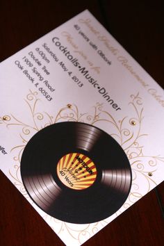 an old record is on top of a wedding program with gold and black lettering,