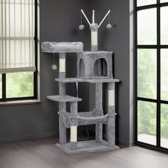 a cat tree in a living room with grey walls