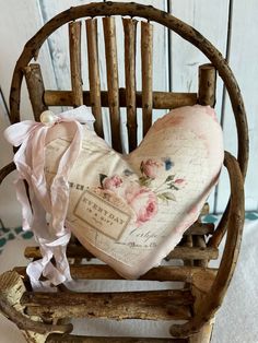 a heart shaped pillow sitting on top of a wooden rocking chair