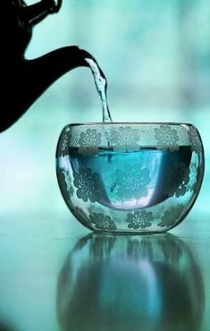 a glass bowl filled with water sitting on top of a table