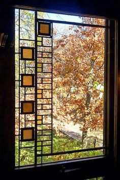 an open window looking out onto a tree