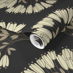 a black and beige floral wallpaper with white flowers on the bottom half of it