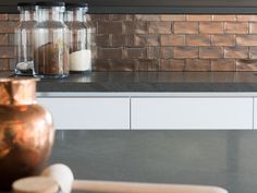 a kitchen counter with two jars on top of it and a rolling pin next to it