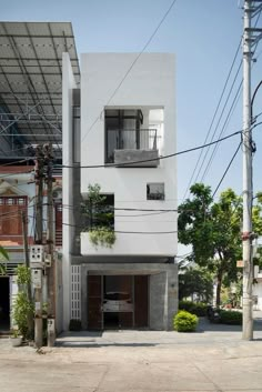 an apartment building with plants growing on the windows