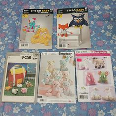 four different catalogs for stuffed animals on a bed