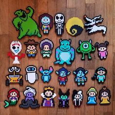 pixel art stickers are laid out on a wooden floor, with different characters in the background