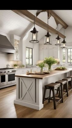 a large kitchen with an island in the center and stools at the end, surrounded by white cabinets