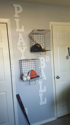 there is a baseball bat, helmet and ball on the wall in this boys room