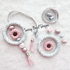 some pink and white items are laying out on a towel with the words sassy bead shoppe written above them