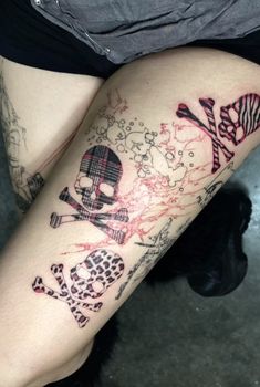 a woman's leg with tattoos on her legs and skull, crossbones, and zebra