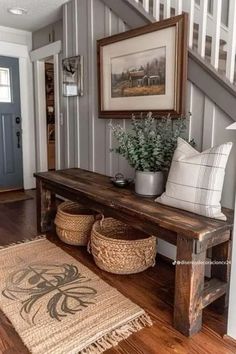 a wooden bench sitting in the middle of a living room next to a stair case