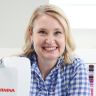 a woman is smiling and holding up a water heater