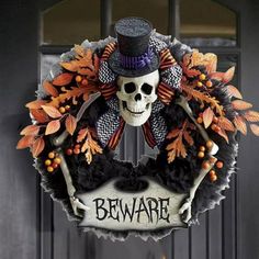 a halloween wreath with a skeleton wearing a top hat