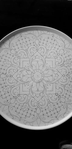 a white plate with an intricate design on it