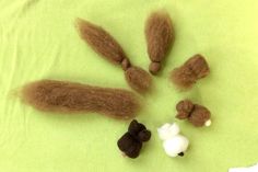 some brown and white stuff sitting on top of a green cloth covered table with other items