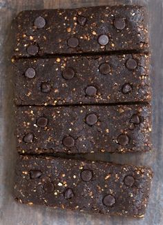 four pieces of chocolate brownie on top of a wooden table